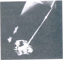 Laser drill hole showing cleavage cracks perpendicular to it and a funnel-like opening (40 x)
